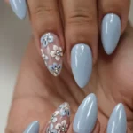 Stylish baby blue nails featuring ombre, French tip, chrome FX, and glitter designs.