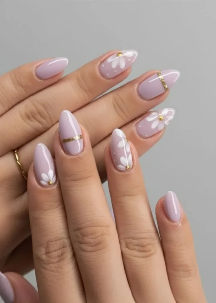 Lavender floral nail art with gold accent design creating a stylish look