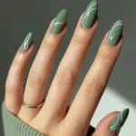 Soft sage nail design with minimalistic curved white lines for 2026 trends