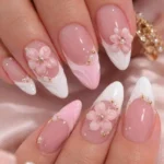Close-up of shiny white French tips on beautifully manicured nails.