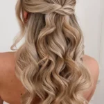 Sleek half-up half-down hairstyle with smooth texture and elegant finish.
