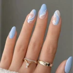 Soft blue aesthetic nails featuring delicate floral nail art design.