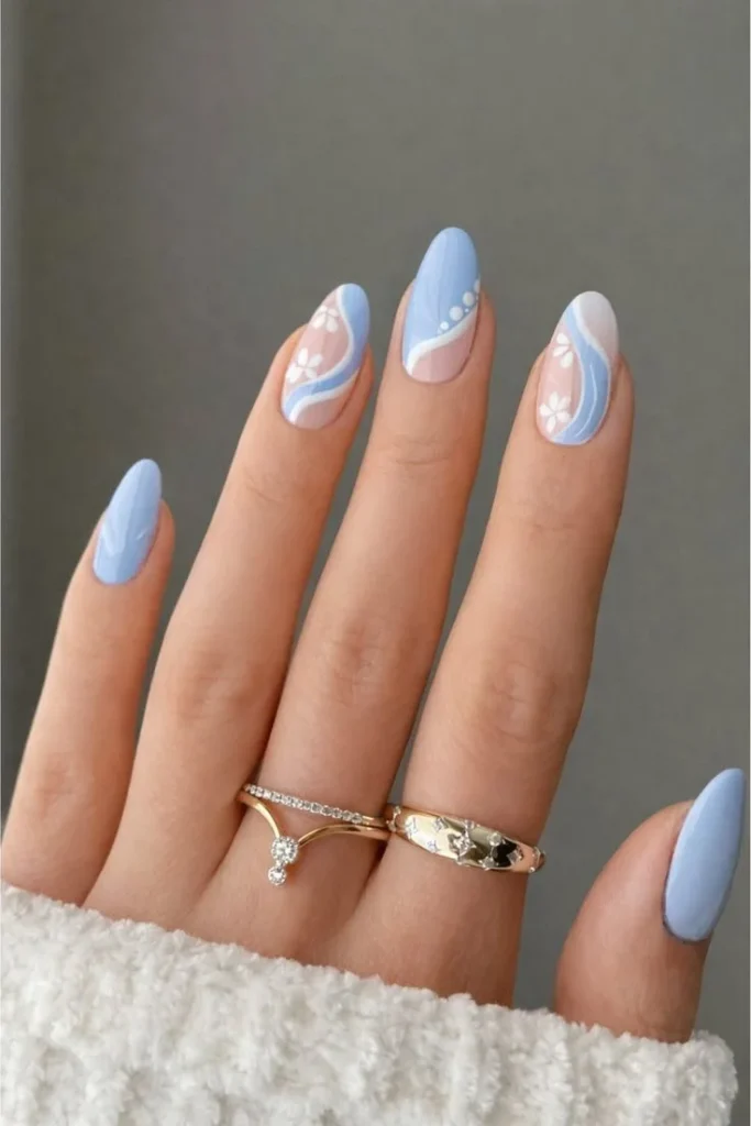 Soft blue aesthetic nails featuring delicate floral nail art design.