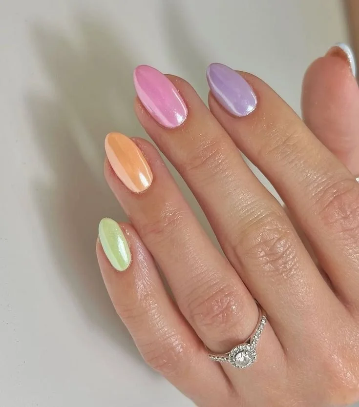 Colorful spring nail art designs featuring floral patterns and pastel colors.