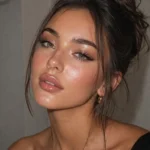 Glossy soft glam look featuring dewy skin and nude lips for 2026 beauty trends.