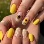 Yellow summer nail design with sunflower and bumblebee accents
