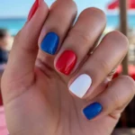 Colorful patriotic nails design featuring red, white, and blue for 4th of July celebrations.