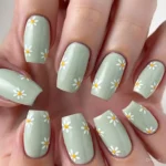 Soft sage green nails with daisy details for busy moms