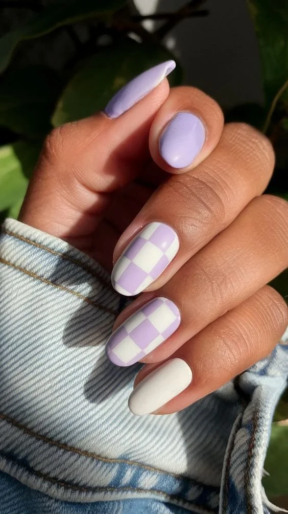 Vibrant neon peach nails featuring miniature heart decals for a stylish nail art design.