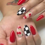 Chic summer red cherry nails aesthetic with vibrant designs and glossy finish.
