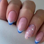 Festive blue star nails design for Christmas manicure inspiration.