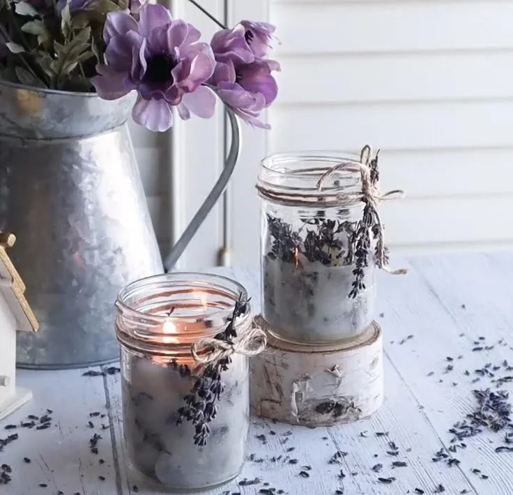 Homemade lavender candles in decorative jars for DIY decor.