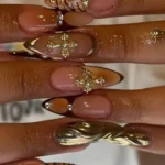 Chic nails featuring gold cross design and cheetah print for busy moms.