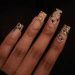 Elegant coffin shaped nails showcasing black and white designs and leopard prints.