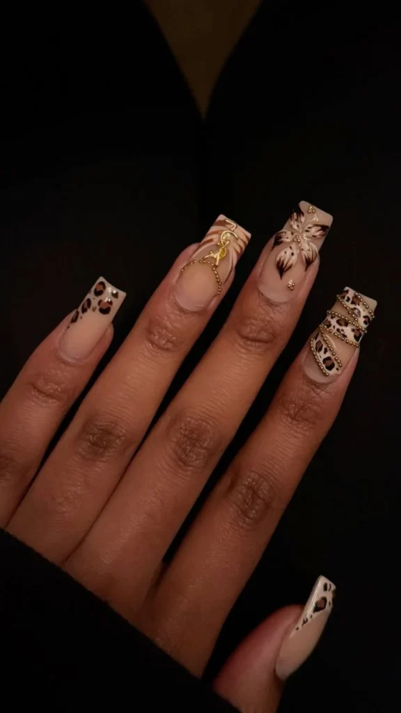 Elegant coffin shaped nails showcasing black and white designs and leopard prints.