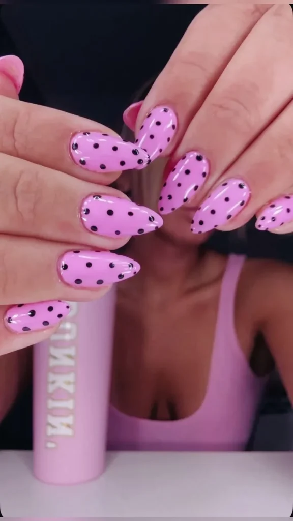 Dot French manicure with pink almond nails and black and white polka dots on tips.