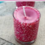 Homemade pumpkin spice soy candle in a cozy setting