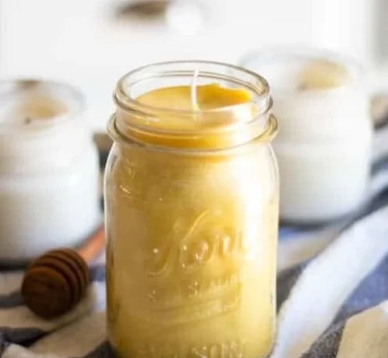 Homemade beeswax candles displayed on a wooden table