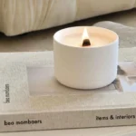 Wellness candle used in quick deep breath rituals for busy moms