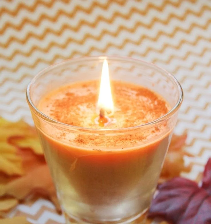 Homemade pumpkin spice candles for fall decoration and fragrance.
