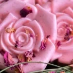 Homemade rose goat milk soap bars arranged on a marble surface