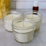 A busy mom crafting a homemade essential oil candle with natural ingredients.