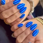 DIY spa with stripe beach towel and nail art ideas for home relaxation.