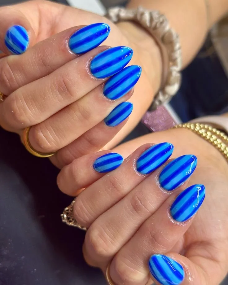 DIY spa with stripe beach towel and nail art ideas for home relaxation.