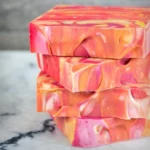 Citrus summer punch swirl soap with colorful designs and fresh fruit accents.