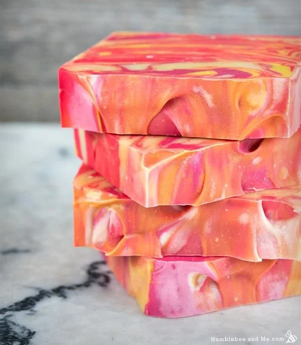 Citrus summer punch swirl soap with colorful designs and fresh fruit accents.