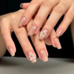 Simple coffin nail ideas featuring soft nude manicure styles