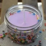 Colorful homemade DIY candles in various shapes and sizes.