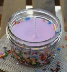 Colorful homemade DIY candles in various shapes and sizes.