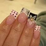 Beautiful acrylic nails featuring charms, animal prints, and Y2K designs.