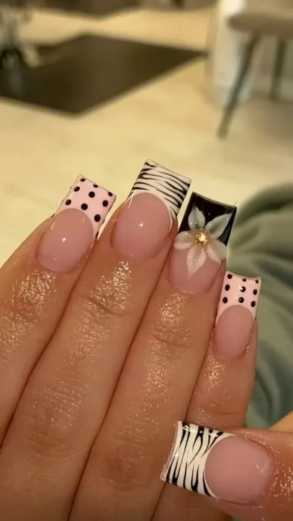 Beautiful acrylic nails featuring charms, animal prints, and Y2K designs.