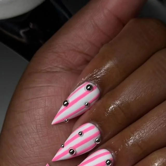 Elegant black and pink almond nail designs with rhinestones