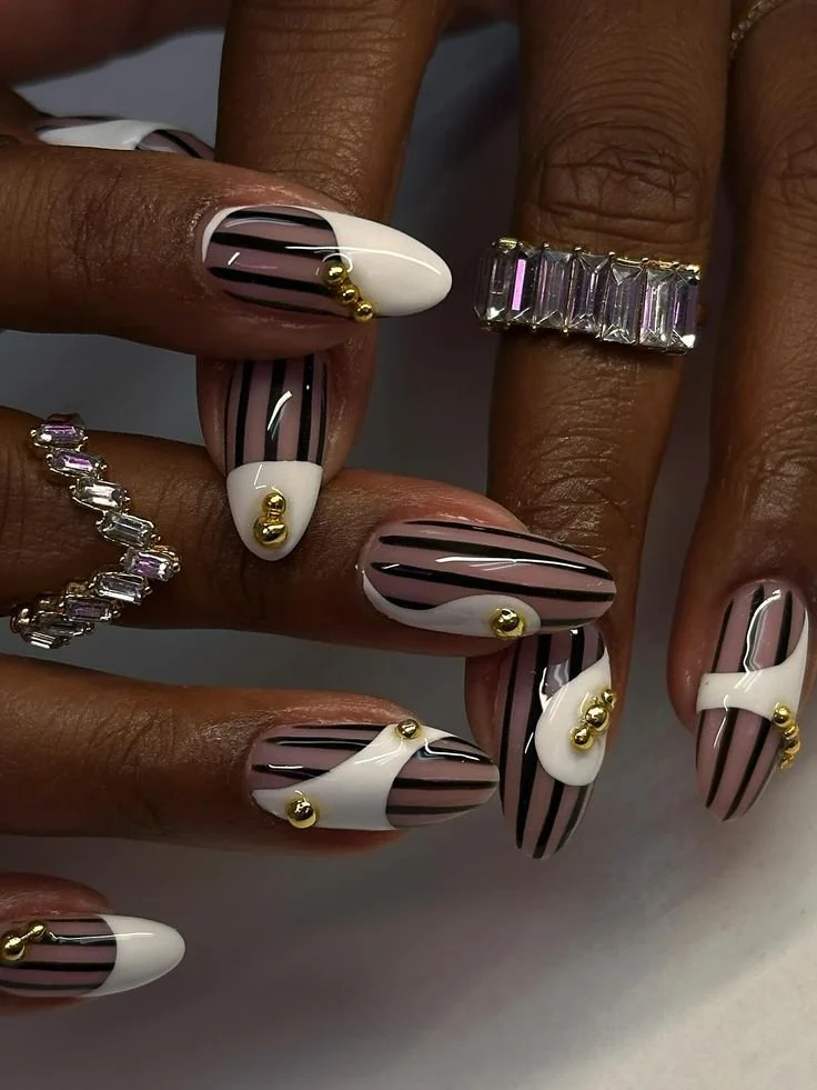 Elegant black white and gold nails design with rhinestones on stiletto acrylics