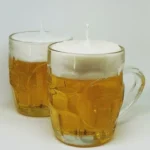 DIY candles made from beer mugs for unique decor and gifts.