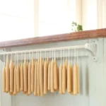 Handmade beeswax taper candles made through candle dipping technique.