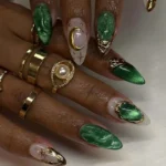 Celestial emerald green cat eye press on nails with 3D gold chrome moon and star design.