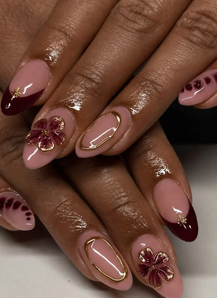 Elegant burgundy nails design with gold accents for summer nail art.