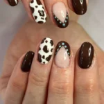 Cowgirl nail art design featuring western themes and unique patterns.