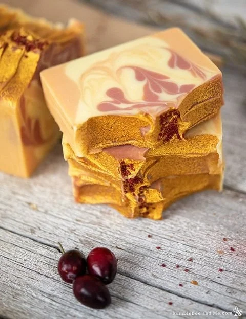 Homemade Cranberry Orange Soap with festive decorations for Christmas crafts