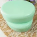 Homemade Cucumber Melon Soap bars on a wooden surface