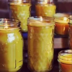 Homemade beeswax candles displayed with natural decorations and scents.