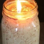 Homemade cinnamon candle lit for a cozy ambiance