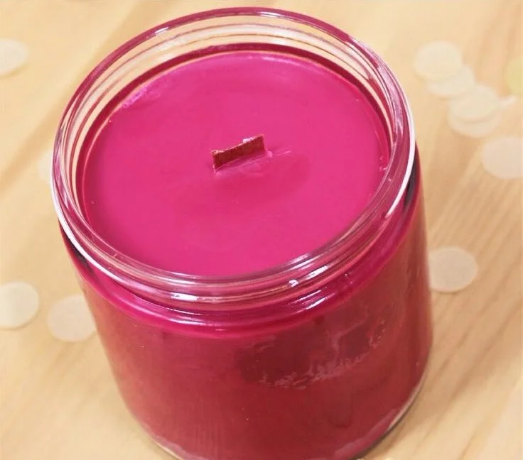 DIY scented candles made from soy wax with wooden wicks and decorative elements.
