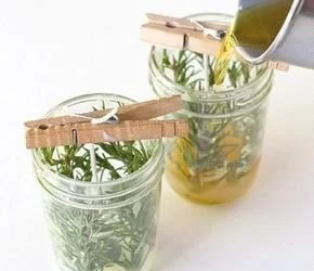 DIY herb candles with rosemary in cozy mason jars for home decor.