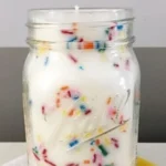 Homemade funfetti mason jar candle with colorful sprinkles