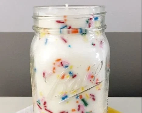 Homemade funfetti mason jar candle with colorful sprinkles